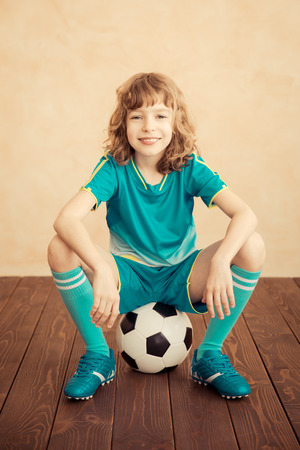 Child is pretending to be a soccer player. Success and winner conceptの写真素材