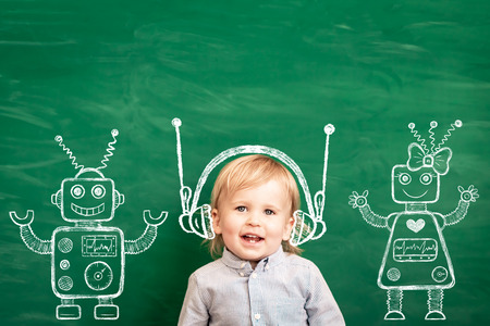 Happy child in class. Funny kid against chalkboard. Back to school. Education conceptの写真素材