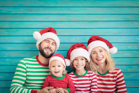Happy family having fun at Christmas time. Father, mother and children at home. Xmas holiday conceptの写真素材