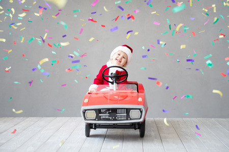 Happy child paying at home. Kid having fun on Christmas time. Xmas holiday conceptの写真素材