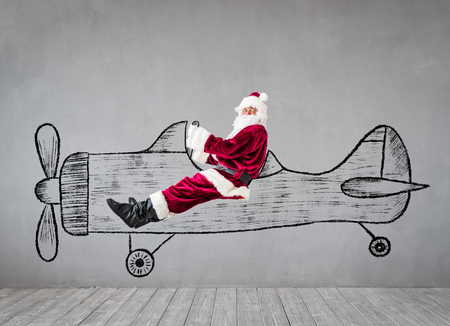 Santa Claus senior man travel by air . Christmas Xmas holiday conceptの写真素材