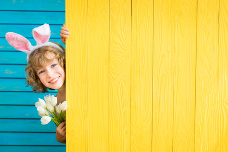 Child Easter bunny holding banner blank. Spring holidays concept