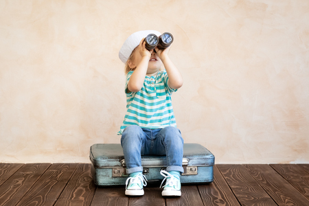Happy child pretend to be sailor. Funny kid playing at home. Summer vacation and travel conceptの写真素材