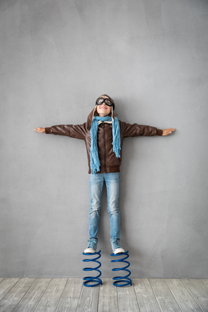 Happy child standing on spring. Success, creative and idea conceptの写真素材