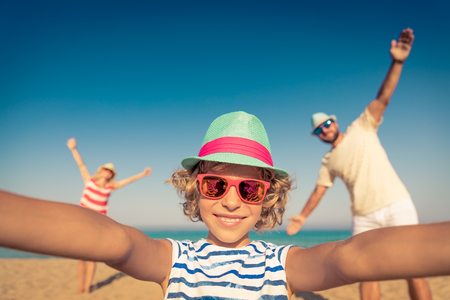 Happy family on summer vacation. People having fun on the beach. Active healthy lifestyleの写真素材