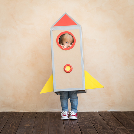 Happy child pretend to be businessmen. Funny kid playing at home. Education, start up and business idea conceptの写真素材
