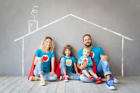 Family of superheroes playing at home. Father, mother, daughter and son having fun together. Parents with children pretend to be a super heroesの素材 [FY310120897164]