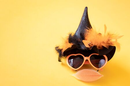 Witch face against yellow background. Happy Halloween conceptの写真素材