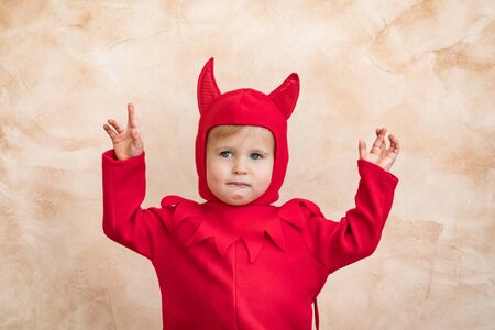 Happy child dressed Halloween costume. Portrait of funny kid at homeの写真素材