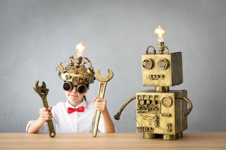 Smart child pretend to be businessmen. Funny kid playing at home. Education, start up and business idea conceptの写真素材