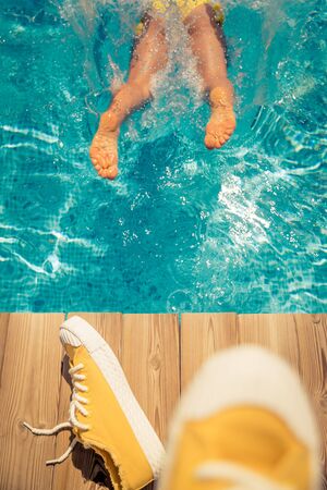 Woman having fun on summer vacation. Person jumping in swimming pool. Active healthy lifestyle concept. Spring break!の写真素材