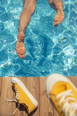 Woman having fun on summer vacation. Girl jumping in swimming pool. Active healthy lifestyle concept. Spring break!の写真素材