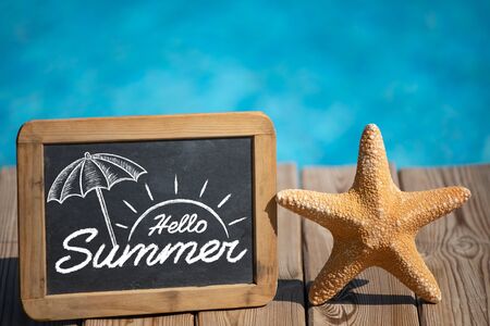 Blackboard blank and starfish on the beach. Summer vacation and travel conceptの写真素材