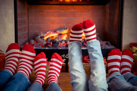 Happy family with children near fireplace at Christmas. Xmas holiday conceptの写真素材