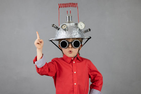 Funny kid wearing helmet with lightbulb.の写真素材