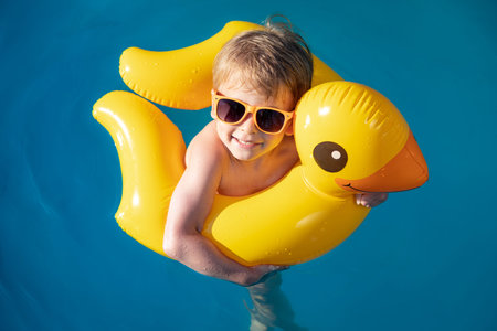 Happy child swimming in pool.