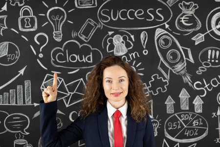 Successful young businesswoman in the office. Woman standing against blackboard. Success business...