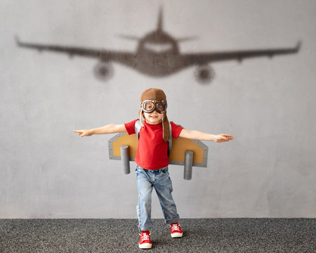 Child pretend to be pilot. Kid having fun at home. Summer vacation and travel conceptの写真素材