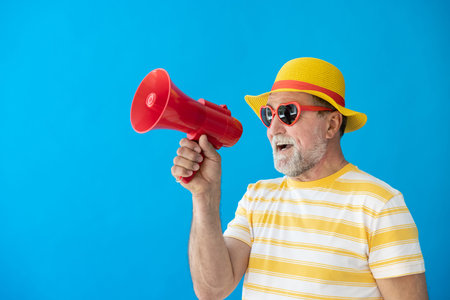 Happy senior man ready to travel. Person shouting through loudspeaker. Summer vacation and holiday...