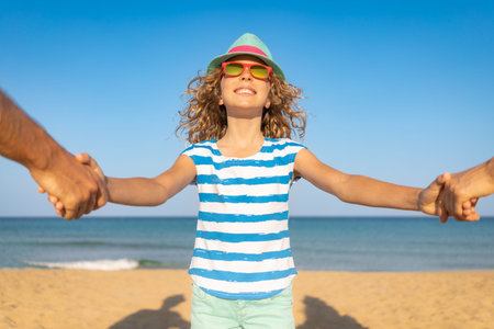 Happy family on summer vacation. Mother, father and child on the beach. People having fun by te sea