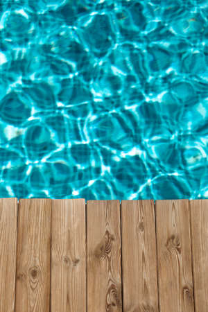 Wooden background against blurred water. Summer vacation conceptの写真素材