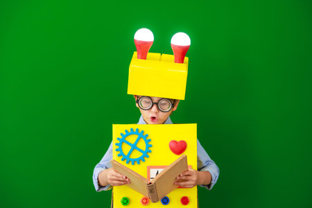 Happy child wearing a robot in school. Funny kid have an idea. Boy in a class. Education, artificial...
