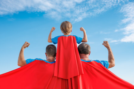 Senior, man and child outdoor against summer blue sky. Grandfather, father and son pretend to be superheroes. People having fun together. family holiday concept. happy father's dayの写真素材