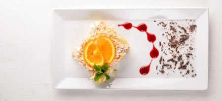 Layered cake with orange flavor. On a wooden background. Free space for your text. Top view.の写真素材