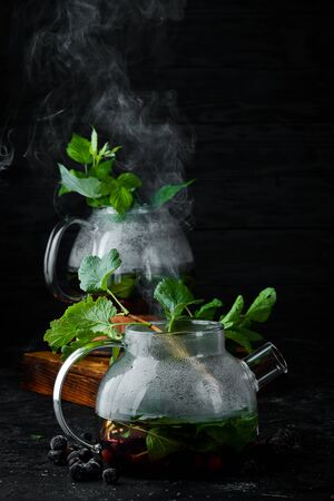 Currant and mint tea. Hot winter drinks. On a black background. Top view.の写真素材