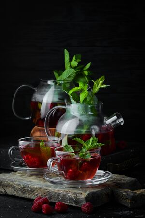 Raspberry and mint tea. Hot winter drinks. On a black background. Top view.の写真素材