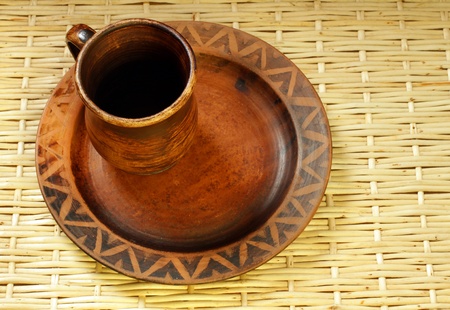 brown clay cup and plate in ukrainian style handmade の写真素材