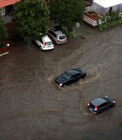 ODESSA, UKRAINE - July 16. Cars attempts to go along the steet through flood waters after a heavy rain on July 16, 2012 in Odessaのeditorial素材