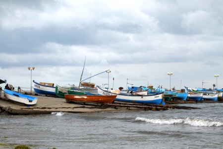old fishing boats floating in the water of Sozopol port in Bulgariaのeditorial素材