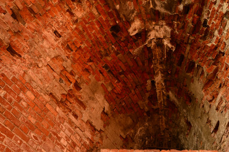 The ruins of an ancient fortress loopholes in brickwork red brickの写真素材