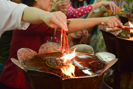hand cense joss stick  to at an incense burne の写真素材