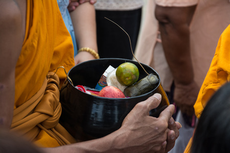 Buddhist monks are given food offering from people for End of Buddhist Lent Dayの写真素材