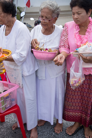 SAMUTPRAKARN, THAILAND - OCT 09 :   Buddhist monks are given food offering from people for End of Buddhist Lent Day. on October 09, 2014 in Samutprakarn,Thailand.のeditorial素材