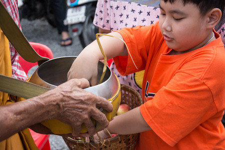 SAMUTPRAKARN, THAILAND - OCT 09 :   Buddhist monks are given food offering from people for End of Buddhist Lent Day. on October 09, 2014 in Samutprakarn,Thailand.のeditorial素材