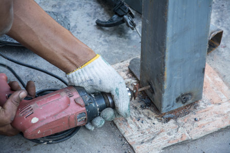 man using drill on metal