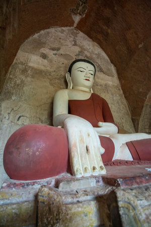 Buddha statue in Ywa Haung Gyi temple of red sandstone, Bagan Myanmar (Burma)のeditorial素材