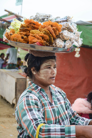 Mandalay, Myanmar - 02 August 2015: Woman selling traditional Burmese street food in Mandalayのeditorial素材