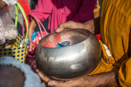 Buddhist monks are given food offering from people for End of Buddhist Lent Dayの写真素材