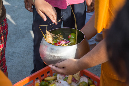 Buddhist monks are given food offering from people for End of Buddhist Lent Dayの写真素材