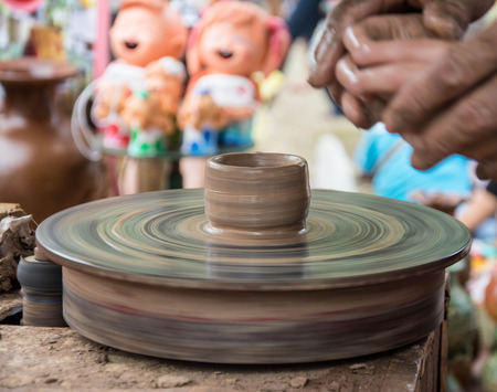 Hands working on pottery wheelの写真素材