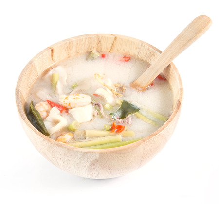 Thai Food Tom Yum Goong in wood bowl isolate on white backgroundの写真素材