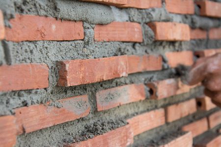 Construction mason worker with trowel and cement mortarの写真素材