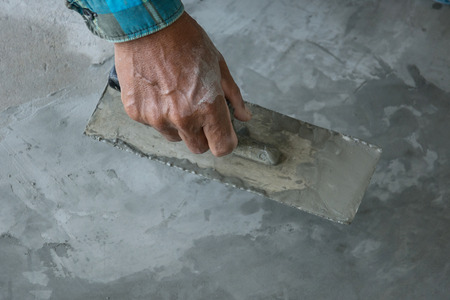 plasterer concrete worker at floor of house constructionの写真素材