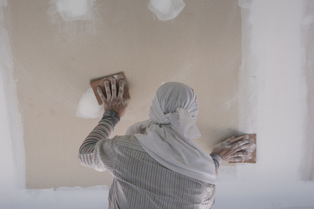 worker used sandpaper for  scrub the ceilingの写真素材