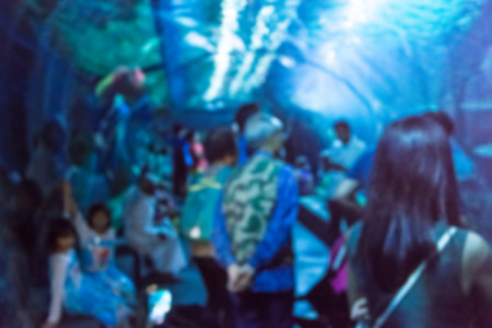 Abstract blurred of people in underwater tunnel at aquarium.の写真素材
