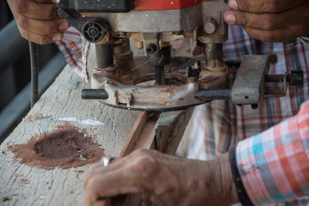 worker use electric woodworking routerの写真素材